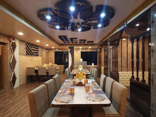 a dining room with a long table and chairs at Hotel WB40 in Durgāpur