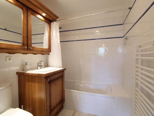 a bathroom with a tub and a sink and a toilet at Appartement Les Carroz d'Arâches, 4 pièces, 6 personnes - FR-1-572-36 in Arâches-la-Frasse