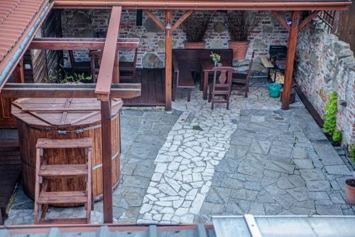 a patio with chairs and a table in a building at Apartamenty przy górskich rzekach in Nowy Targ
