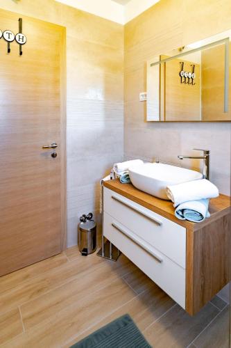 a bathroom with a sink and a shower at Arba sunshine in Rab