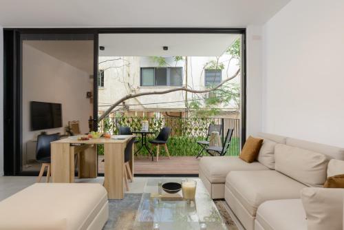 a living room with a couch and a table at The Unexpected by HolyGuest in Tel Aviv