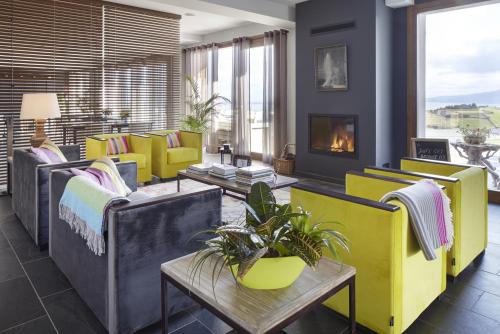 a living room with couches and a fireplace at Hotel San Prudentzio in Getaria