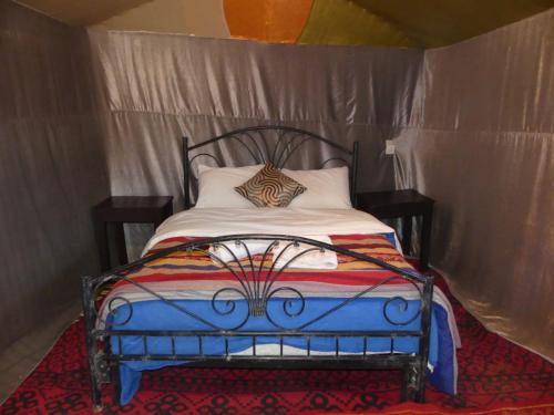 a bedroom with a bed in a tent at Overnight Desert Camp in Merzouga