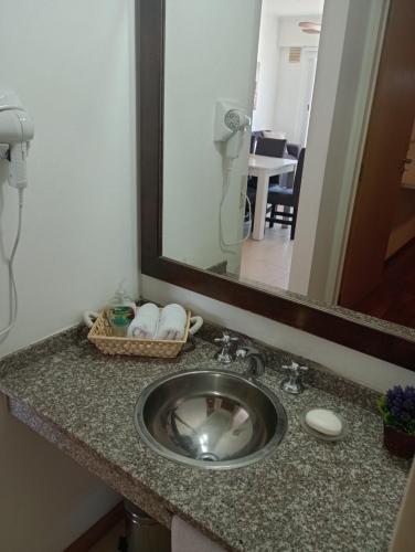 a bathroom counter with a sink and a mirror at Colina Dom in Victoria