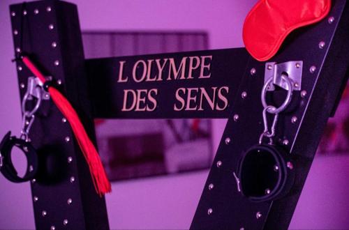 a cross with a pair of scissors attached to it at L'OLYMPE DES SENS in Portiragnes