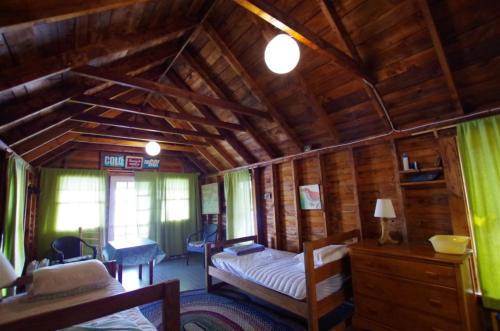 a bedroom with a bed in a wooden cabin at Rock Fern in Sunapee