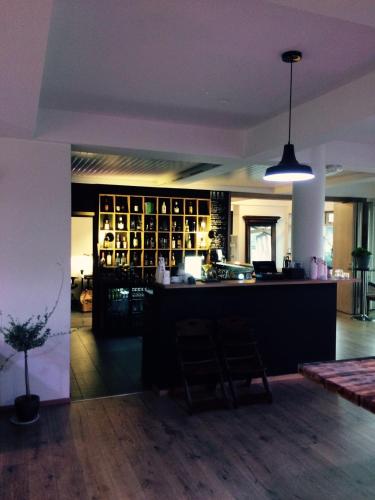 a bar in a room with a counter in a room at Fugl Fønix Hotel in Etnesjøen