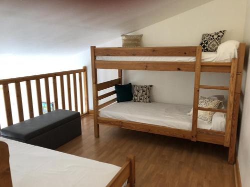a room with two bunk beds and a bed at Chalets Moulière Evasion in Montamisé