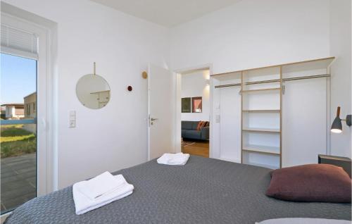um quarto branco com uma cama e uma porta de vidro deslizante em Stunning Home In Lembruch-dmmer See With Sauna em Lembruch