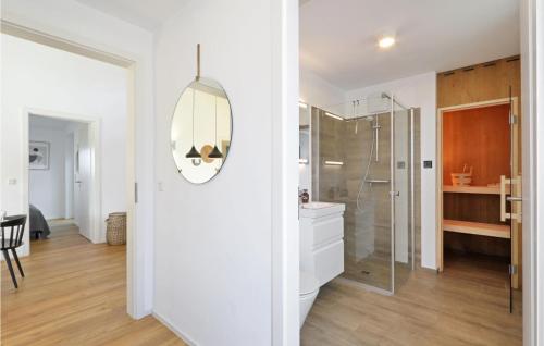 a white bathroom with a shower and a mirror at Nice Home In Lembruchdümmer See in Lembruch