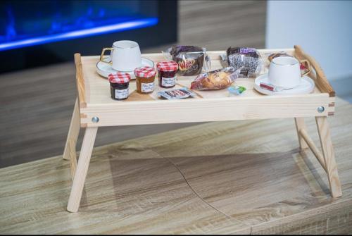a wooden table with food and drinks on it at L'OLYMPE DES SENS in Portiragnes