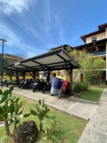 a group of motorcycles parked under a pavilion at Coconut Room - Entre mer et forêt avec piscine in Rémire-Camp