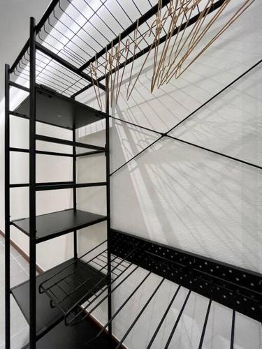 a shelf in a room with a glass wall at Coconut Room - Entre mer et forêt avec piscine in Rémire-Camp