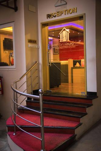 a set of stairs in front of a store at Hotel Sri Hayagriva in Srīrangam