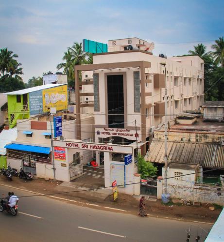 a building on the side of a city street at Hotel Sri Hayagriva in Srīrangam