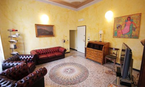 a living room with leather couches and a television at Due Papi in Savona