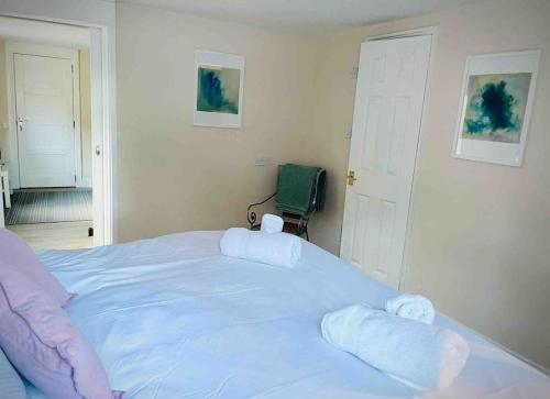 a bedroom with a large bed with towels on it at Cosy Flat, close to Bath Rugby and City Centre in Bath