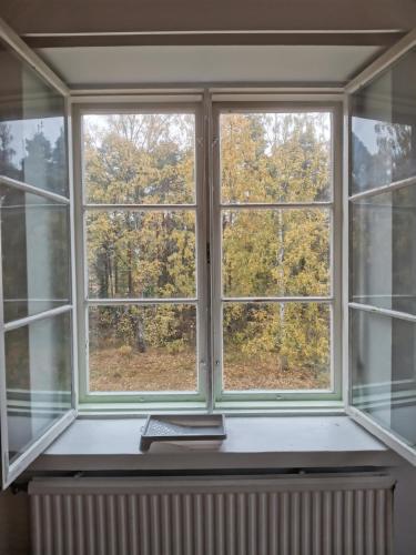 a window with a book on a window sill at Relaxing Beatiful Studio - Sauna Bath Facility in Kotka