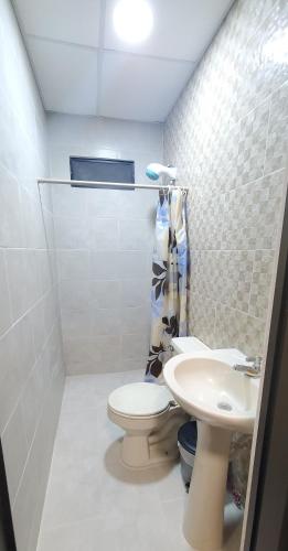 a bathroom with a toilet and a sink at NCG Suite in Guayaquil