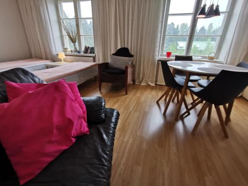 a living room with a couch and a table at Relaxing Beatiful Studio - Sauna Bath Facility in Kotka