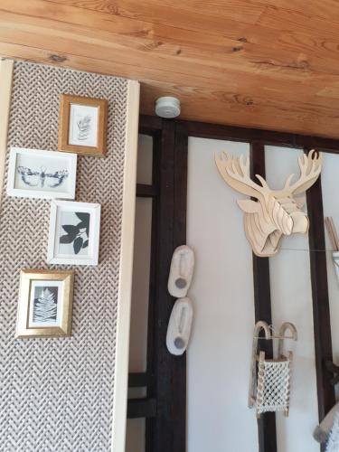 a room with a wall with pictures on it at Chalet le logis des autre in Vireux-Wallerand