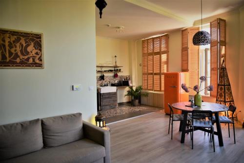 a living room with a couch and a table at SLEEP INN - 1001 Nights Loft Citycenter with Balconyview in Antwerp