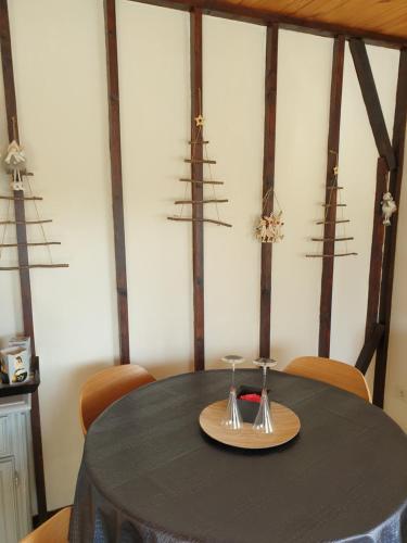 a table with two wine glasses on top of it at Chalet le logis des autre in Vireux-Wallerand