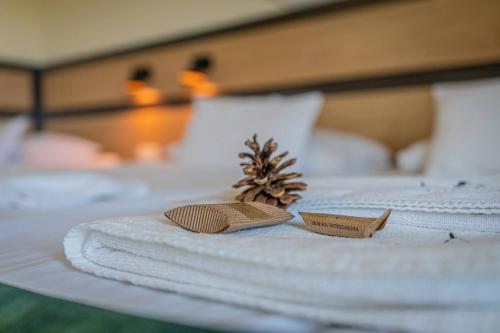 a bed with two towels and two candles on it at Rezydencja Markowy Dworek in Białka Tatrzanska