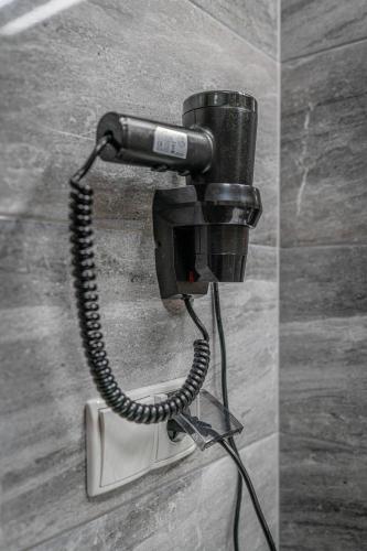 a phone is attached to a wall in a bathroom at Rezydencja Markowy Dworek in Białka Tatrzanska