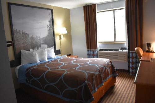 a hotel room with a bed and a window at Super 8 by Wyndham La Vale/Cumberland Area in La Vale