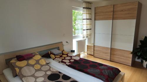 a living room with a bed and a large window at moderne 4 Zimmer -Wohnung I BBQ I Parkplatz in Munich