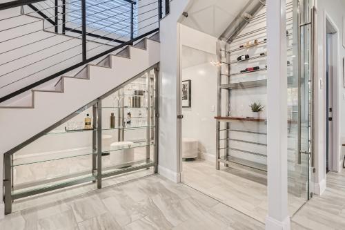 a staircase in a home with white walls and glass shelves at Luxury 5 BDRM Home! Blocks To DT/Riverwalk/Convention Center! in San Antonio
