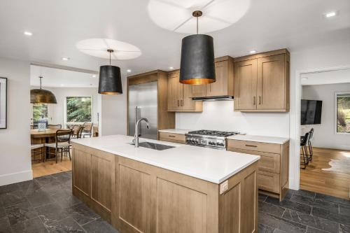 a kitchen with wooden cabinets and white counter tops at Welcome to the Modern Mountain Luxury! home in Avon