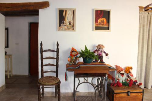 a table with some figurines on it next to a chair at Finca Santa Rita in Corralito