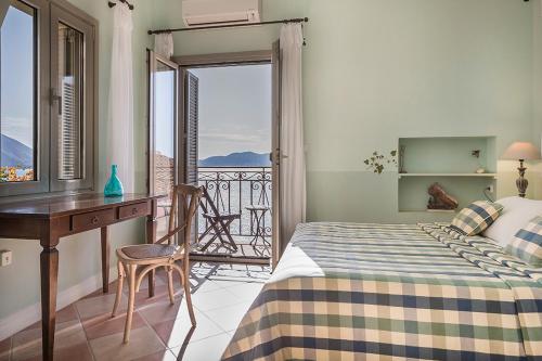 a bedroom with a bed and a desk and a balcony at Roi Boutique Suites in Asos