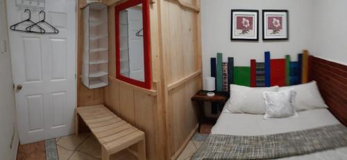 a bedroom with a bed and a shelf with books at Apartamento Deluxe Lake Panajachel in Panajachel