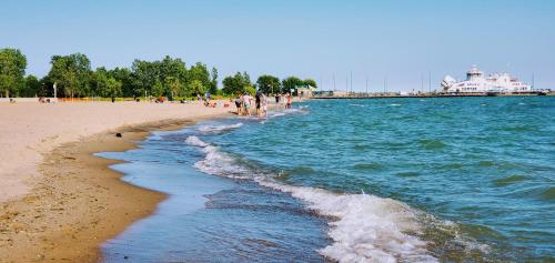 a group of people walking on the beach at Coastal Suite #1 Cozy Suite #2 - Seacliff Beach Suites in Leamington