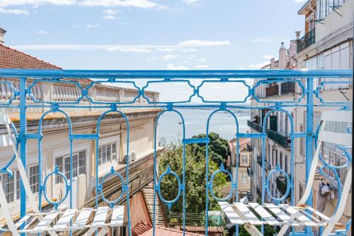 a blue and white bench sitting on top of a sidewalk at Chiado 44 in Lisbon