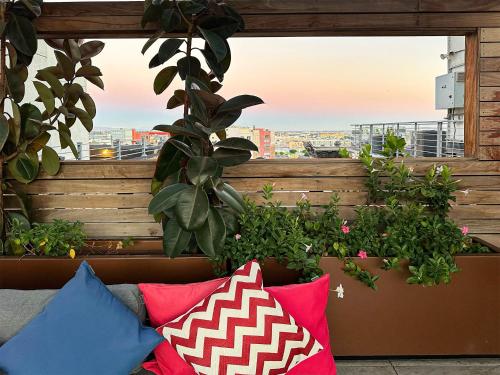 a balcony with pillows and a view of a city at Fashion Loft 2 bedroom Downtown in Los Angeles