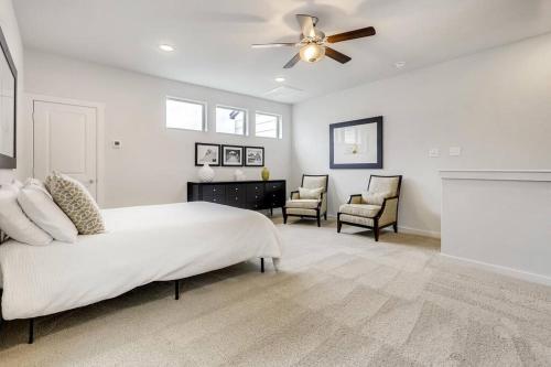 a white bedroom with a bed and a ceiling fan at Gorgeous 4 Bed Home on St Mary's - Minutes to Riverwalk/Pearl in San Antonio