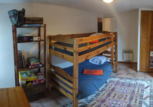 un letto a castello con un letto blu in una camera di Gîte au calme avec superbe vue : La Talonie a Mouret