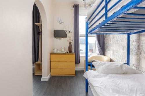 a bedroom with a blue bunk bed and a dresser at The B & B Blackpool in Blackpool