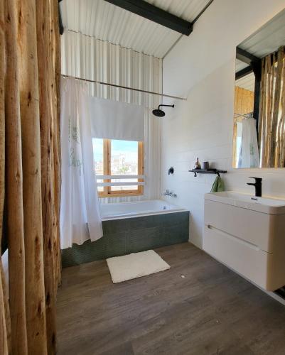 a bathroom with a bath tub and a sink at El Santuario in Paracas