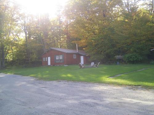 a small red house on the side of a road at Green Mountain Cabins in Killington