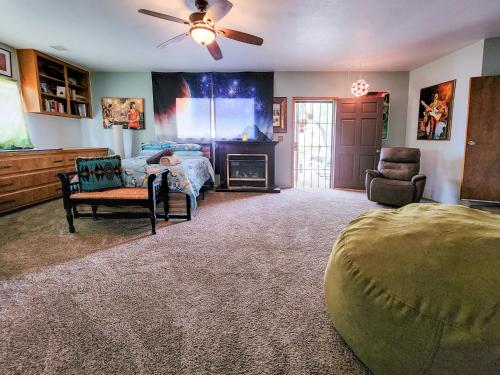 a bedroom with a bed and a ceiling fan at Lunar Eclipse on 4 acres w hot tub in Yucca Valley