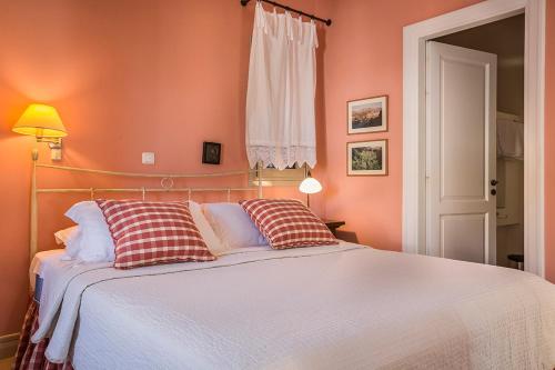 a bedroom with a large bed with orange walls at Roi Boutique Suites in Asos