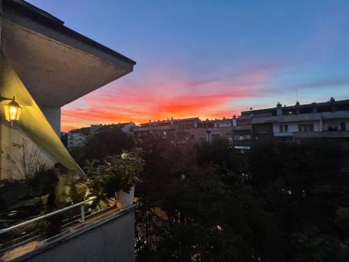 a view of a sunset from the balcony of a building at Apartman Avenia in Novi Sad