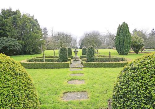 a garden with bushes and a path in the grass at Garden View in Parham