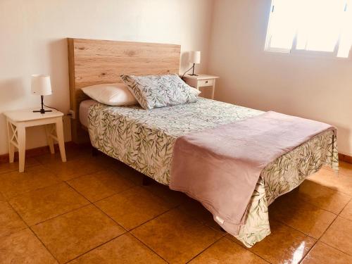 a bedroom with a bed and two night stands at Mar y Montaña Apartamento entero in La Costa
