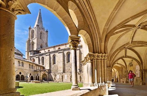 a person walking through a building with a church at Résidence Bury in Tulle